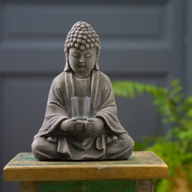 Cement Buddha statue with offering glass