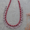 Indian ethnic necklace with flowers and red pearls